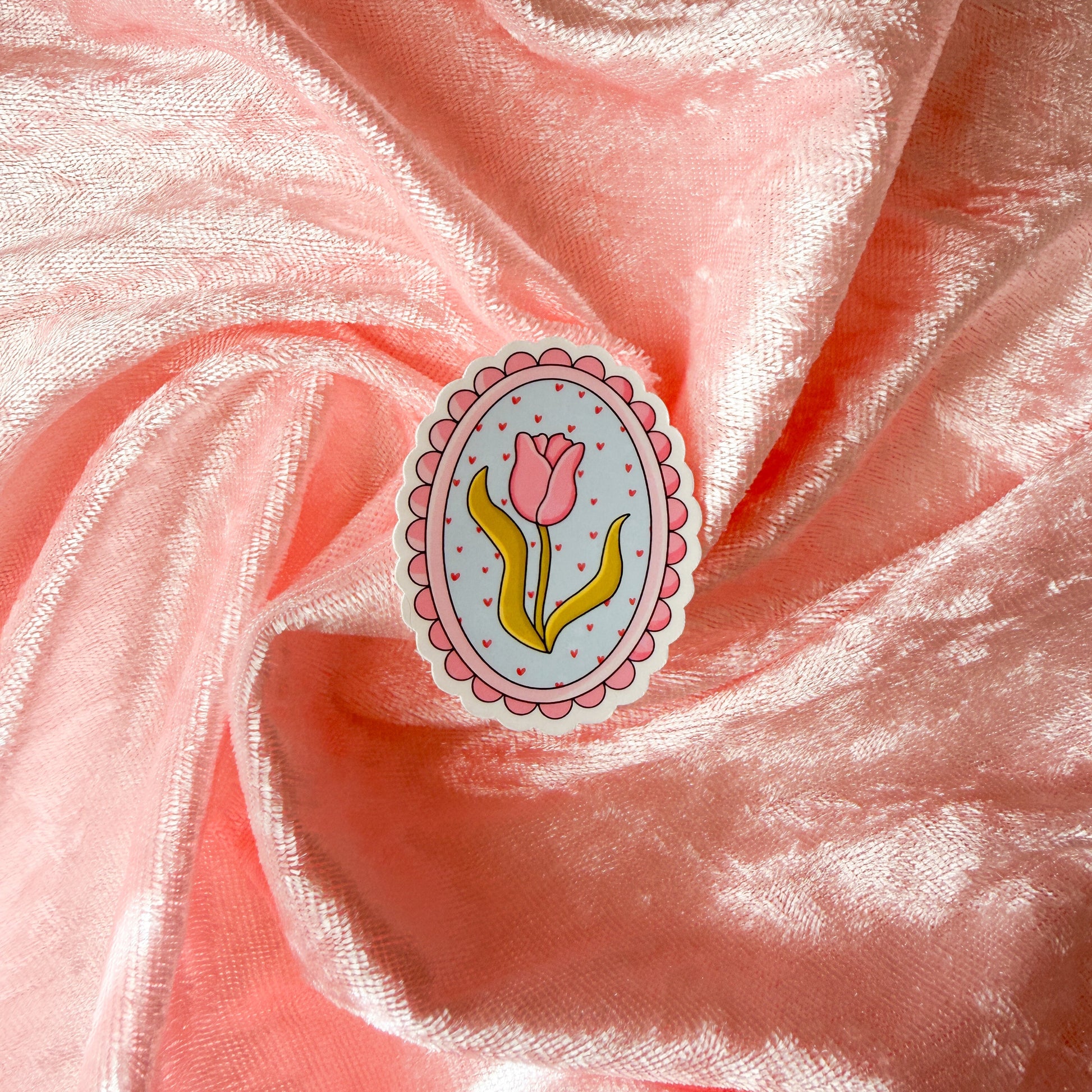 Decorative sticker with a tulip design on pink fabric