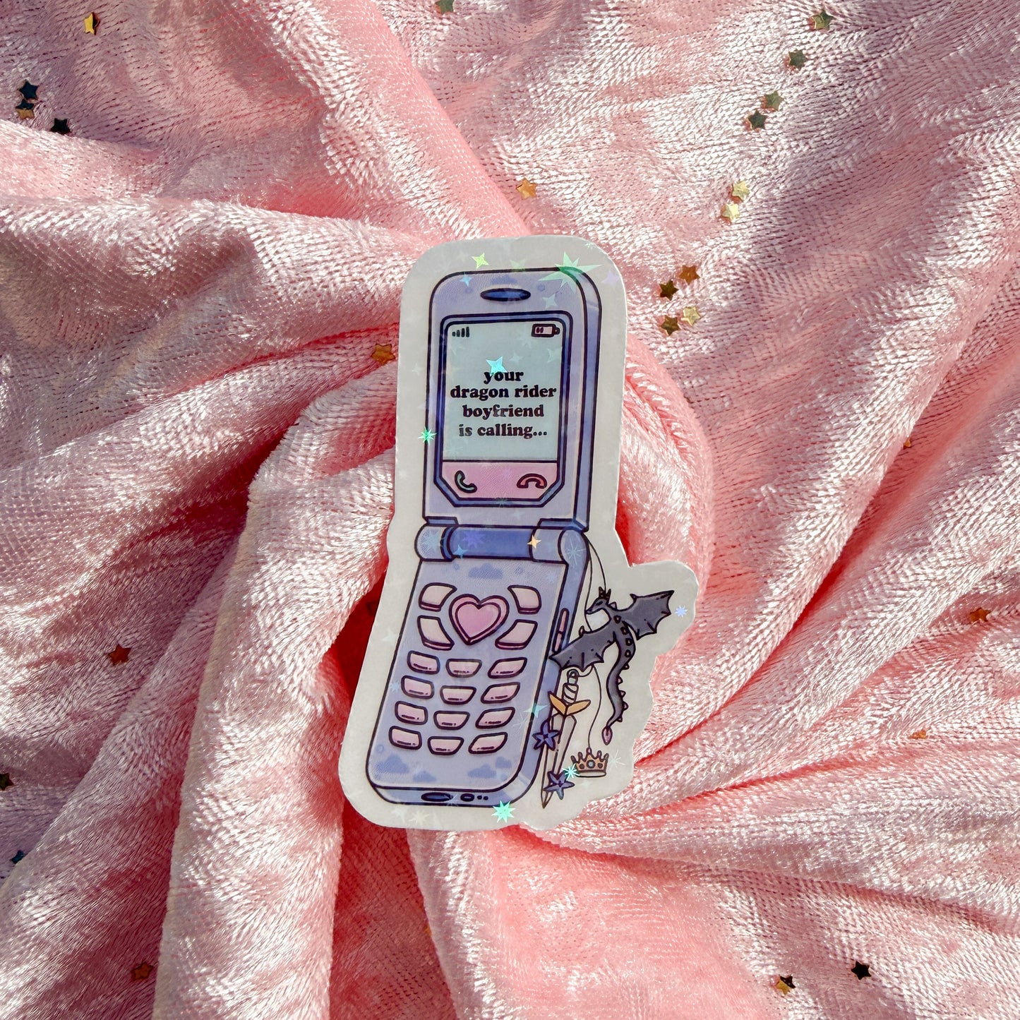A die-cut sticker featuring a retro flip phone with a dragon tail and the text 'your dragon rider boyfriend is calling.